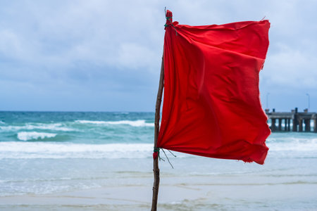 Maritime Alert: The Red Flag and Sea's Call for Cautionの写真素材