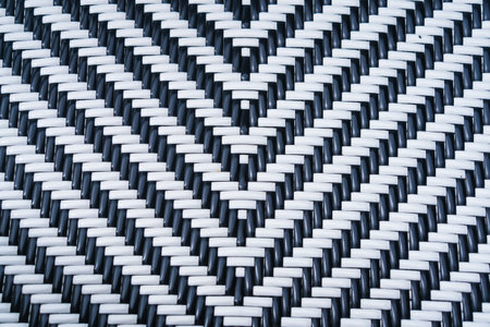 abstract background of pattern of black and white plastic handcraft weave design for textureの写真素材
