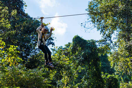Chiang Mai, Thailand - January,04, 2024: Tourist on a zip line, An activity in a hill at Pong Yaeng...