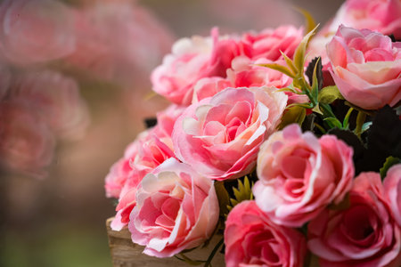 A beautiful display of pink roses in a wooden box, capturing the elegance and freshness of the flowers.の写真素材