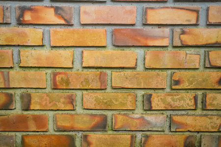 This image captures the rustic charm of a brick wall, with its aged and weathered surface.の写真素材