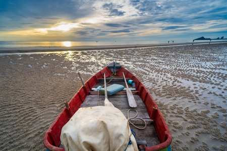 A fishing boat at dawn, with the sky painted in hues of blue and orange, reflecting the beauty of...