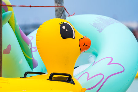 A stack of colorful animal-shaped inflatable floats, including flamingos and unicorns, is ready for...