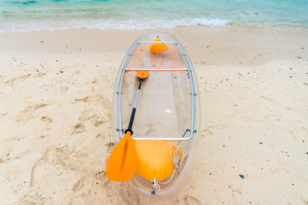 A clear canoe on a tropical beach, perfect for underwater photography and marine exploration.の写真素材