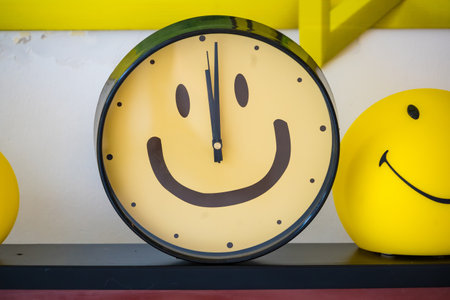 A fun and quirky wall clock featuring a smiley face, perfect for adding character and charm to any living space.の写真素材