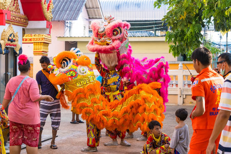 Samut Prakan, Thailand -May, 13, 2024 :Traditional Chinese Lion Dance with Festive Pink and Orange Costumes at Samut Prakan, Thailand.のeditorial素材
