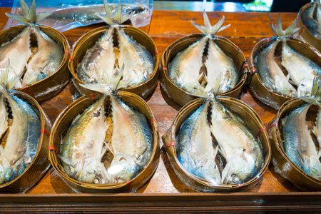 A vibrant display of freshly caught mackerel, beautifully arranged in traditional bamboo baskets, showcasing the rich marine life of Thailand.の写真素材