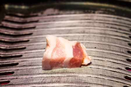Experience the authentic taste of Korean BBQ with grilled pork cooked over charcoal, offering a smoky flavor that elevates your dining experience to new heights.の写真素材