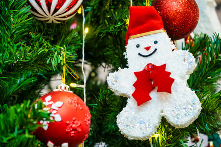 Christmas tree decoration with snowman and red baubles on backgroundの写真素材