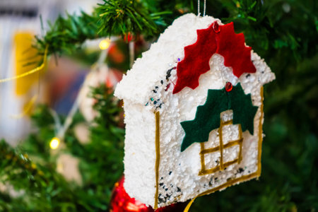 Christmas decoration with gingerbread house on christmas tree. Close upの写真素材