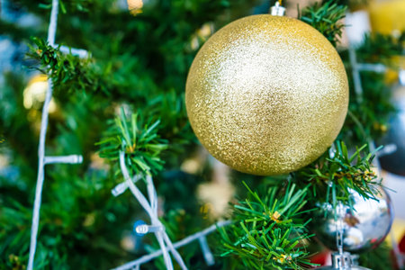 Close up of golden christmas bauble decoration on Christmas tree.の写真素材