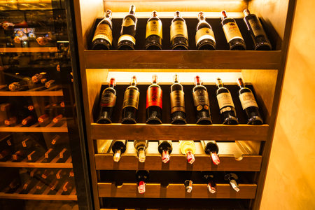 Chonburi, Thailand - November, 18, 2024: An Artful Arrangement of Red Wines in a Refined Wooden...