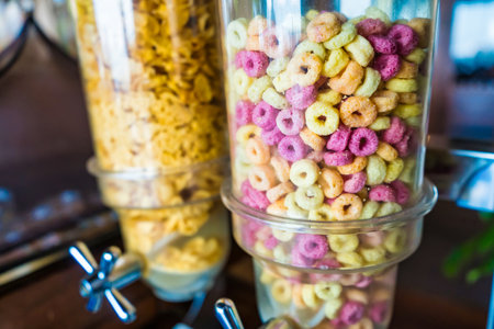 Colorful cereal dispensers in a modern kitchen, perfect for a vibrant breakfast.の写真素材