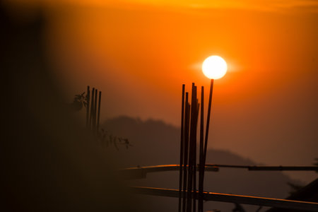 Silhouette of Steel Structure Against a Golden Sunrise Skyの写真素材