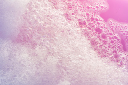 Fluffy White Soap Foam Floating in a bathtub Under Sunlight, Perfect for Spa, Wellness, and Relaxation-Themed Concepts in a Natural Settingの写真素材