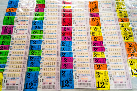 Bangkok, Thailand - December, 18, 2024 :Stacks of colorful lottery tickets arranged side by side in a pattern, displaying numbers and details in multiple rows at Bangkok, Thailandの写真素材