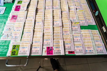 Bangkok, Thailand - December, 18, 2024 :Stacks of colorful lottery tickets arranged side by side in...