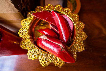 Red wooden fortune sticks in a gold tray used for Buddhist fortune telling in Thai temples.の写真素材