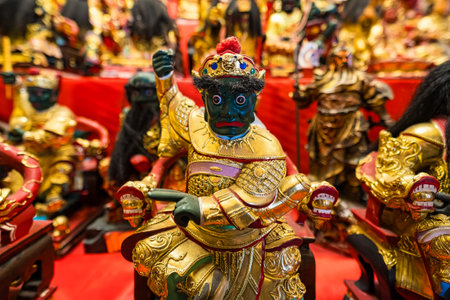 Ayutthaya, Thailand - March, 10, 2025 : A vibrant display of traditional Asian figurines, including...