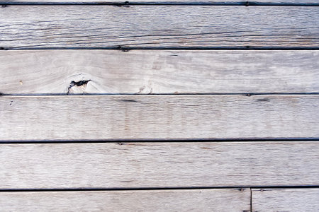 Close-up of weathered wooden planks with a rustic texture and varied shades of brownの写真素材