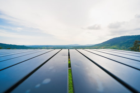 Close-up of a shiny black wooden table on a patio with a scenic view of a lush green valley and...