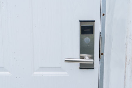 White door with electronic keypad lock and lever handle showcasing modern security featuresの写真素材