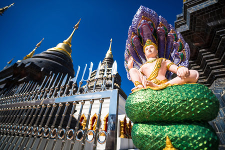 Chiang Mai, Thailand - January, 06, 2026 : Majestic temple complex showcasing intricate architecture and vibrant colors under a clear blue sky, evoking a sense of spiritual peace and cultural richness.の写真素材