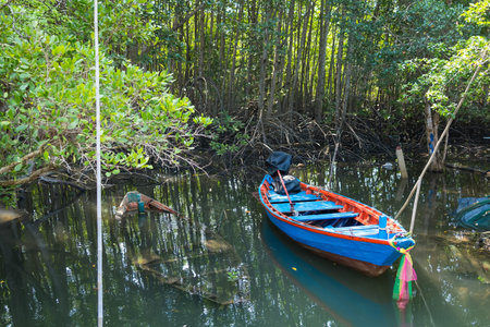 Serene Lagoon Scene: A blue boat rests peacefully in the calm waters of a tropical lagoon,...