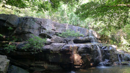 Stones arranged in a long line of juice stream , causing waterfallの写真素材