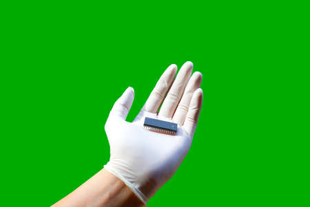 Hand of wearing rubber gloves with integrated circuit,isolate photoの写真素材
