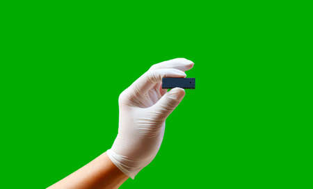 Hand  of  wearing rubber gloves  with integrated circuit,isolate photoの写真素材