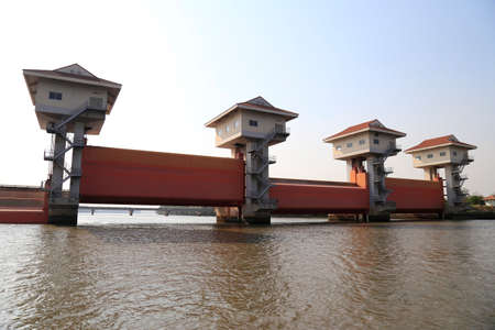 Bang Pakong Dam  are adjustable gates used to control water flow in flood barriers, river, at Chachoengsao  Province, Thailandの写真素材