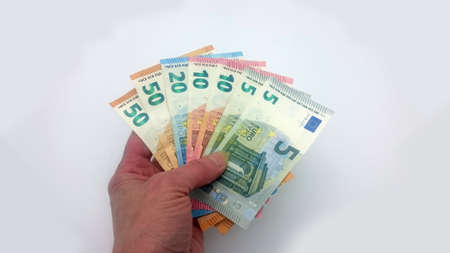human hand holding various euro billsの写真素材