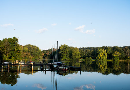 Jetty with sailboats at the first rays of the sun with water reflections. Location: Germany, North Rhine Westphalia, Hoxfeldのeditorial素材