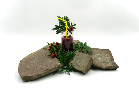 Delicious fruit smoothie with blackberries and straw on stones.Studio shot in front of white background.の写真素材