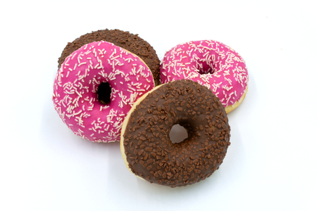 Pink and chocolate donuts isolated on white. Studio shot on white backgroundの写真素材