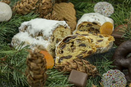 Baked apple and Butterstollen on pine branches.Studio shot as a closeupの写真素材