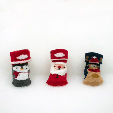cute baby socks with Christmas motive on white fleeceの写真素材