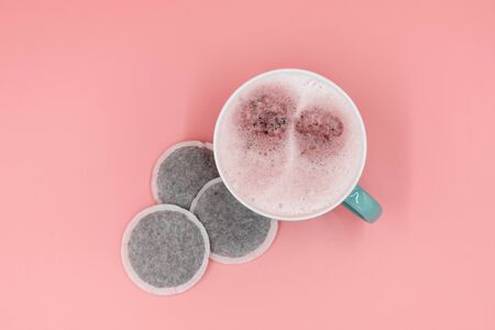 Coffee with whipped milk and coffee pods in redの写真素材