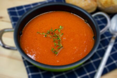 tasty tomato soup in rural style arranged in close-up.
