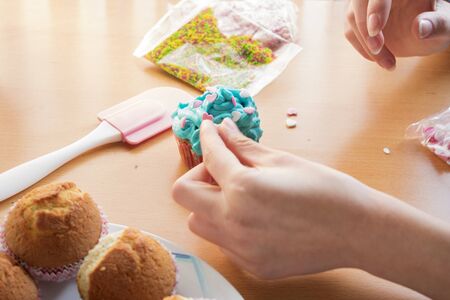 decorating a homemade cupcakes with hearts