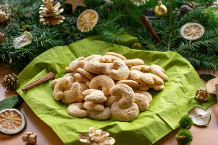 delicious vanilla crescents in front of a arrangement of fir branchesの写真素材
