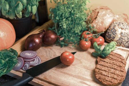 Ingredients for a vegetarian hamburger on a wooden board.の写真素材