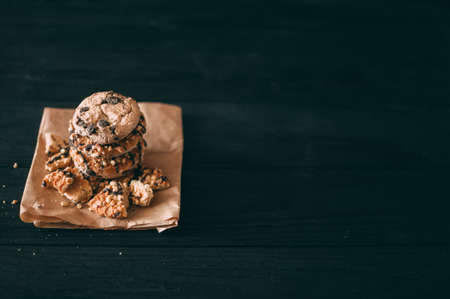 Chocolate chip cookies on dark old wooden table with place for text., freshly baked. Selective Focus with Copy spaceの写真素材