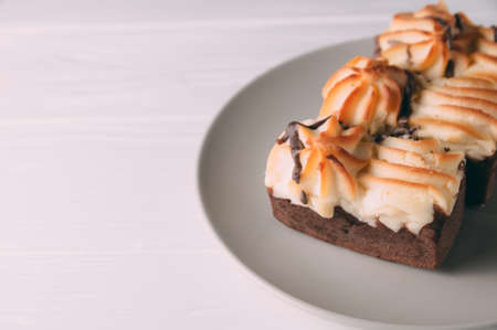 curd cake in a plate lies on a wooden backgroundの写真素材