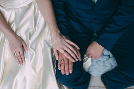 Palms of the newly-married couple with wedding rings.の写真素材