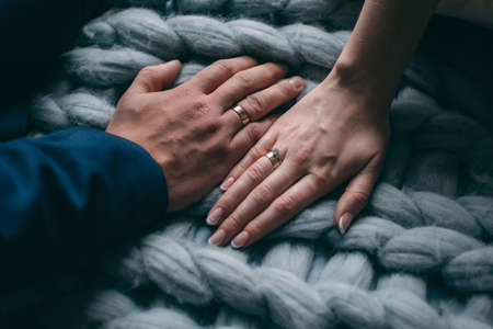 Palms of the newly-married couple with wedding rings.の写真素材