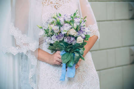 Bride holding her wedding bouquet in her hands.の写真素材