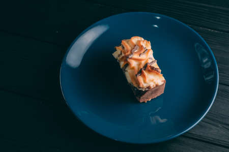 curd cake in a plate lies on a wooden backgroundの写真素材