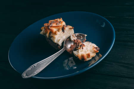 curd cake in a plate lies on a wooden backgroundの写真素材
